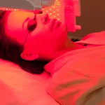 woman wearing under eye patches during red light facial therapy