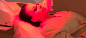 woman wearing under eye patches during red light facial therapy